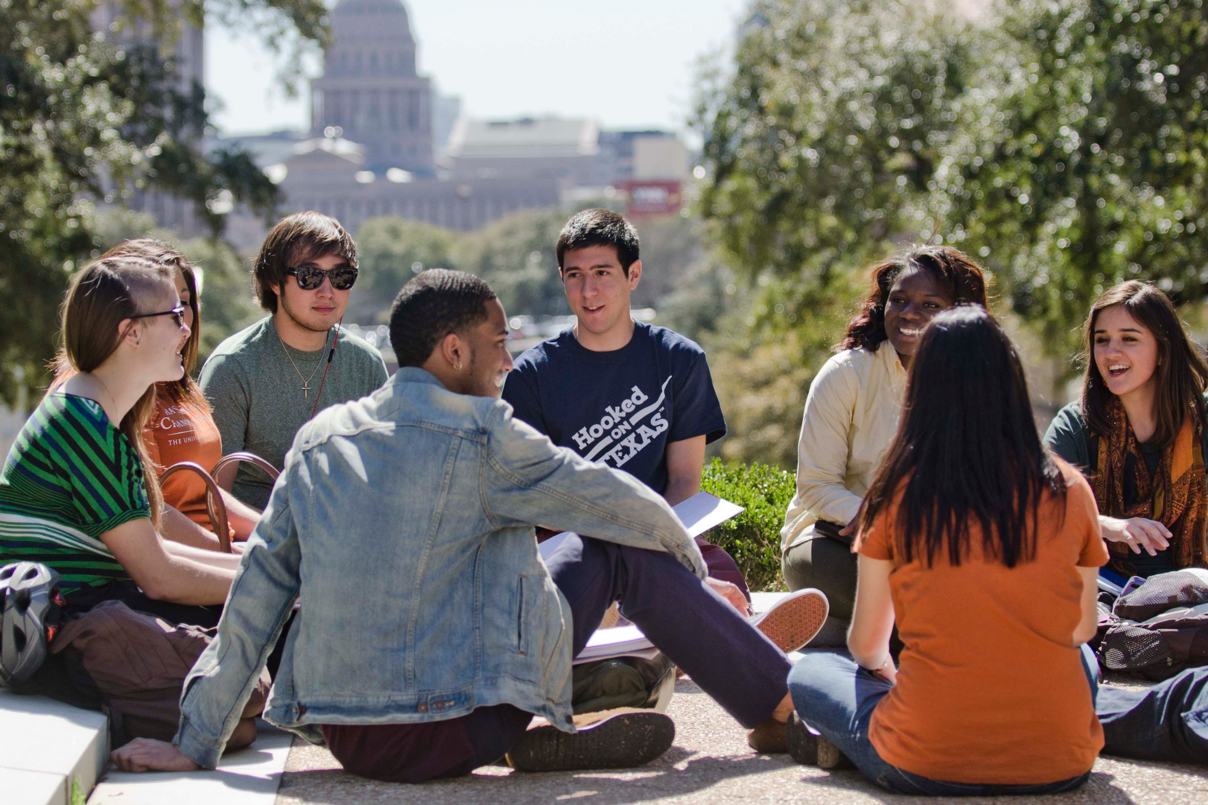 Students sitting in a circle outside
